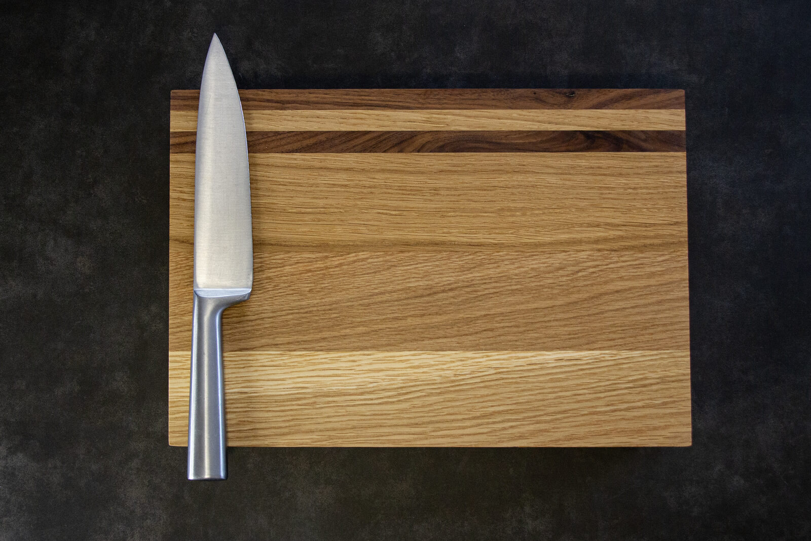 Knife resting on a wooden chopping board